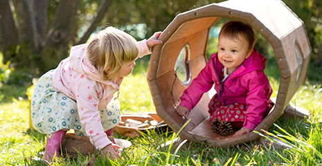 Two girls playing in a Toddler Outlast Tunnel.