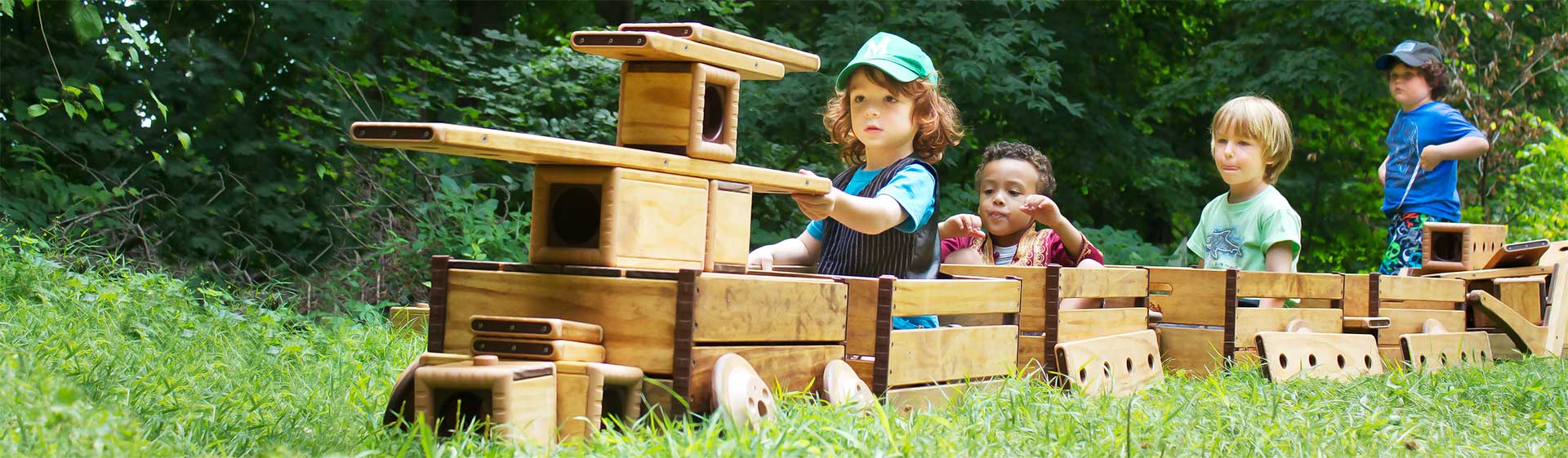 Kinder spielen auf einem Zug aus Holzbausteinen