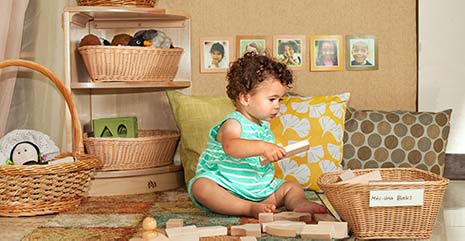 toddler playing with mini unit blocks