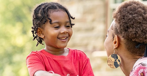 banner teacher talking with child