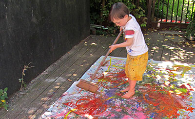 Child painting on the ground