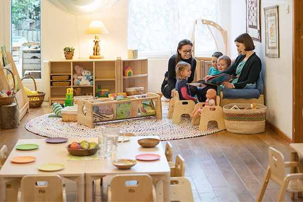 Kinder genießen die Märchenstunde auf einem niedrigen Sofa