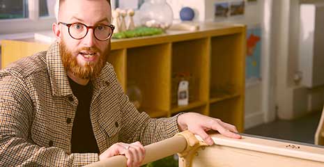 A teacher demonstrates the functions of the Activity tray-table