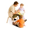 teacher reading to children on low teacher chair
