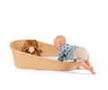 Baby climbing into coracle floor bed