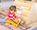 girl by toddler bookshelf