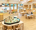 solid wood tables and chairs set up in a reception classroom