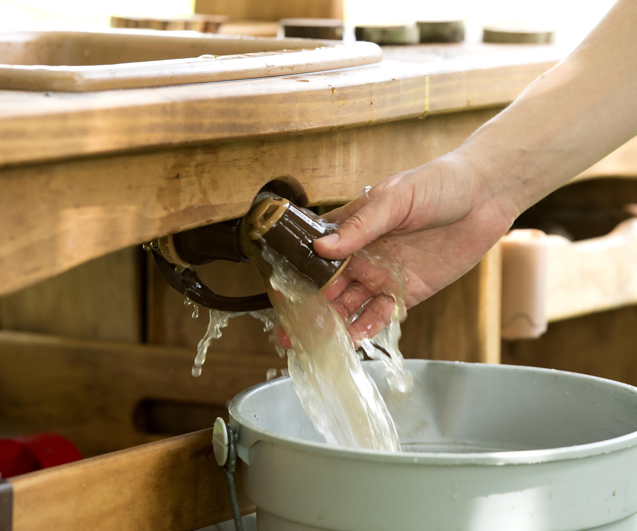 Water from the Outlast kitchenette sink is drained into a bucket