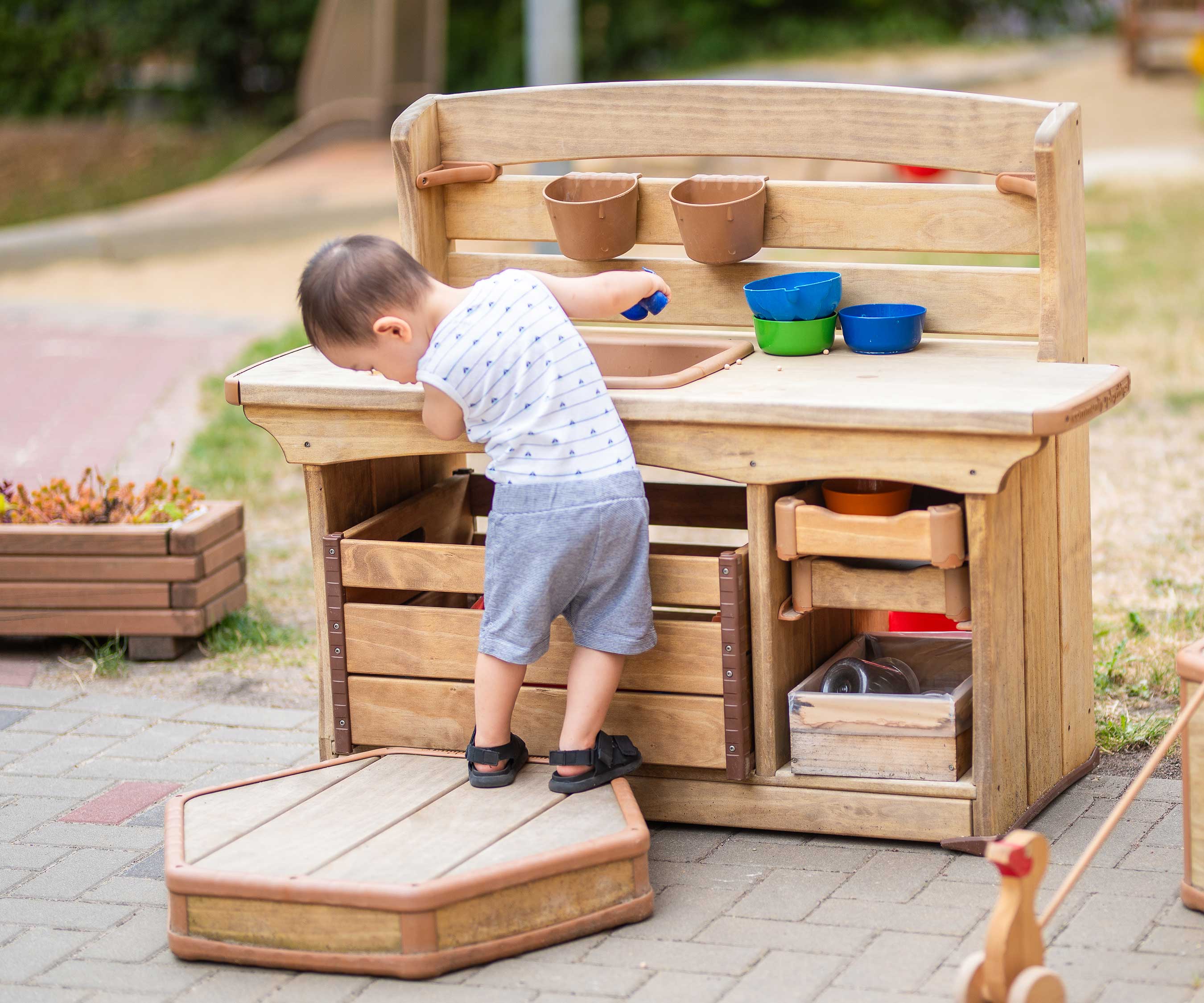 boy at mud kitchen