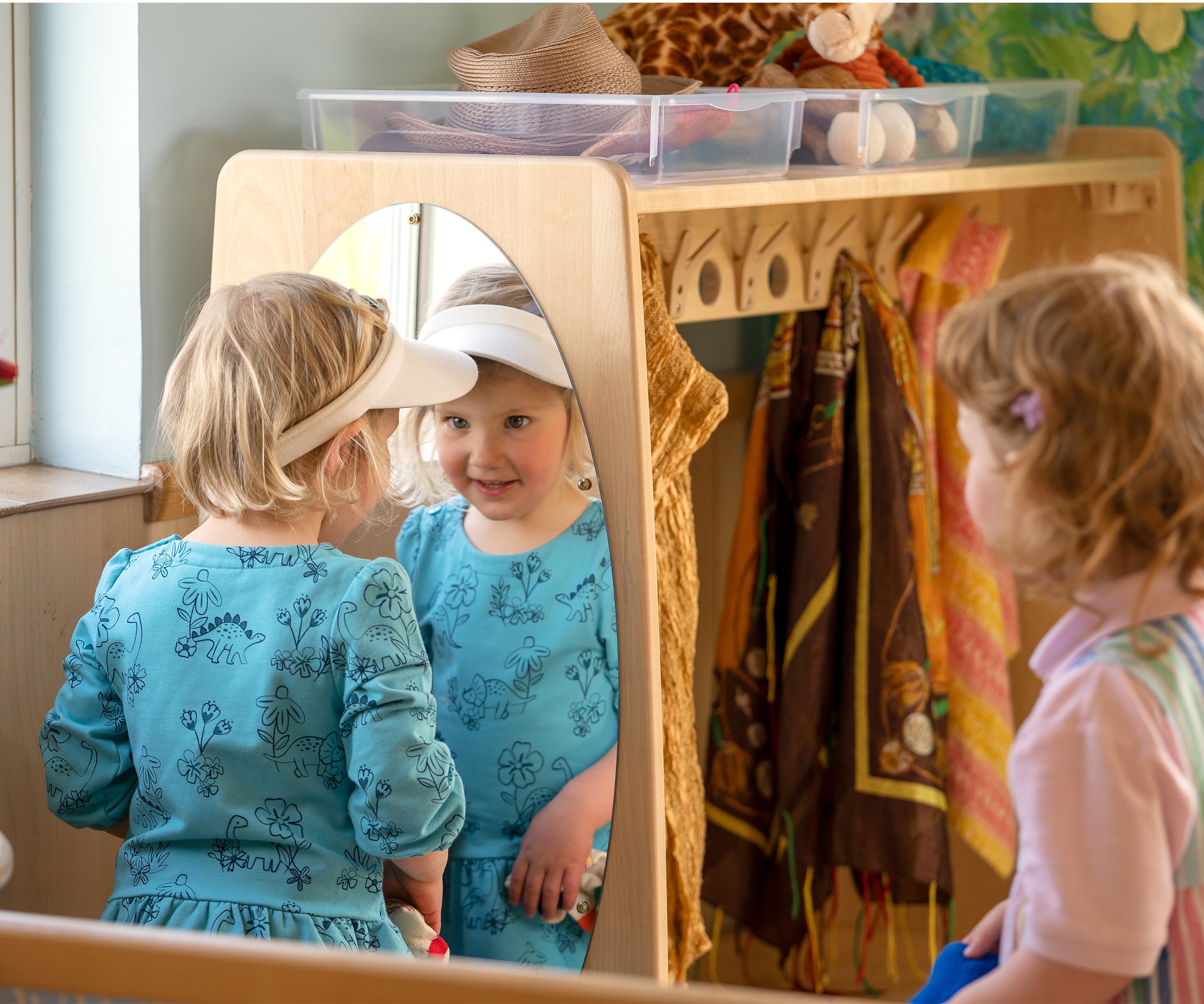 Two girls playing dressups by a Drama centre,.