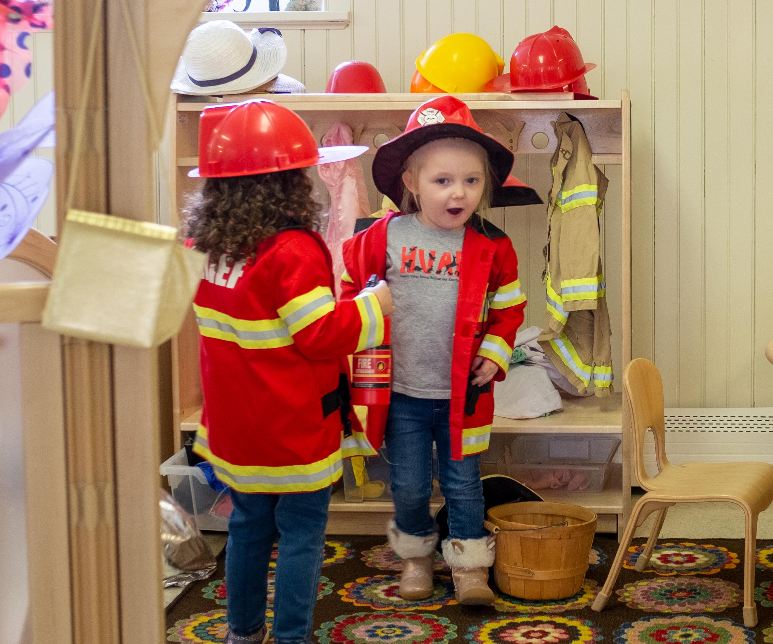 A boy playing dressups by  a Drama centre.