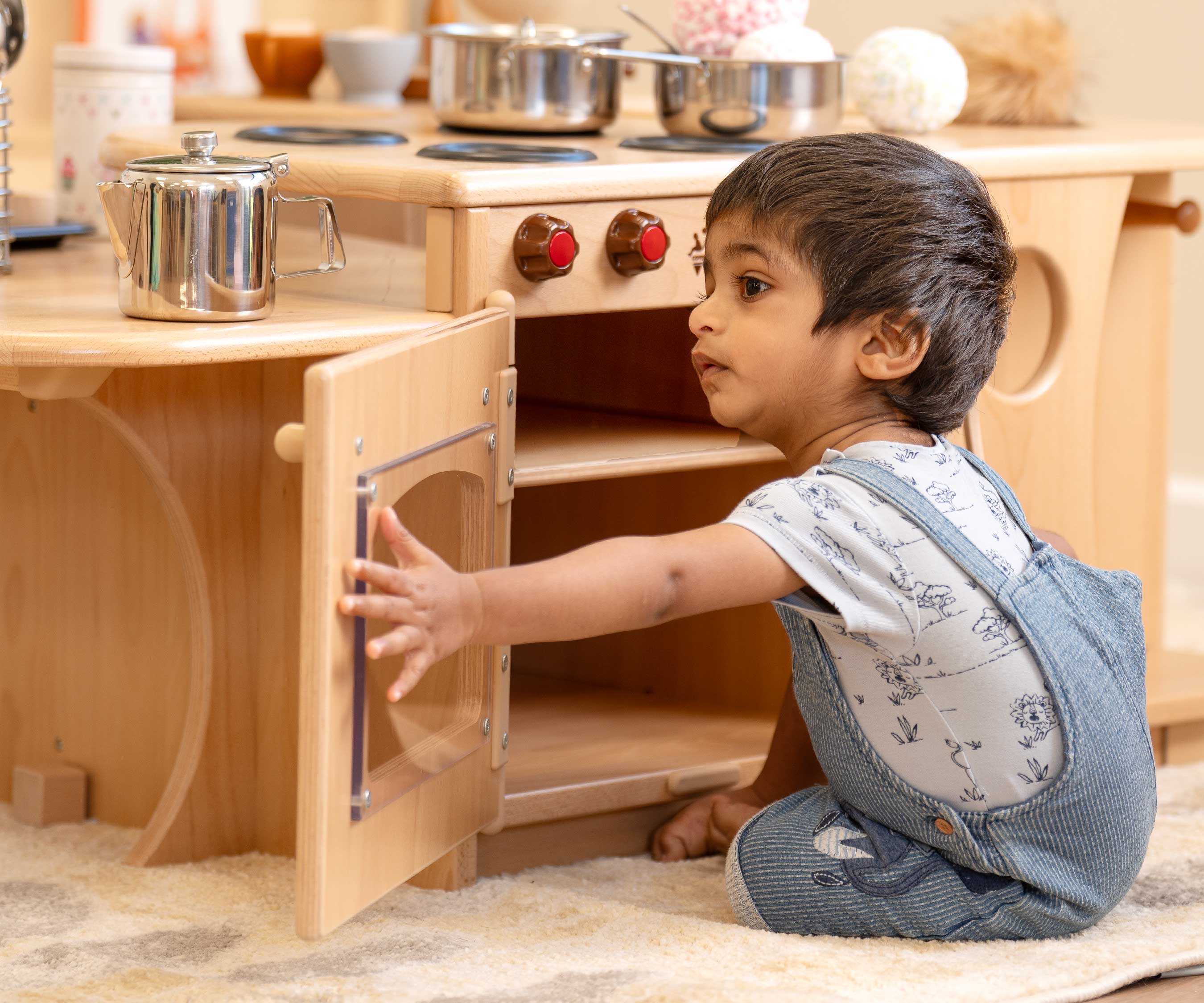 Little boy by low kitchen island