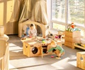 A two year old girl and boy playing at a solid wood Starter home corner