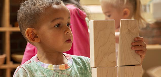 A boy stacking blocks.
