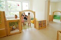 Eine Erzieherin interagiert mit Kindern in einem von Roomscapes definierten Spielbereich